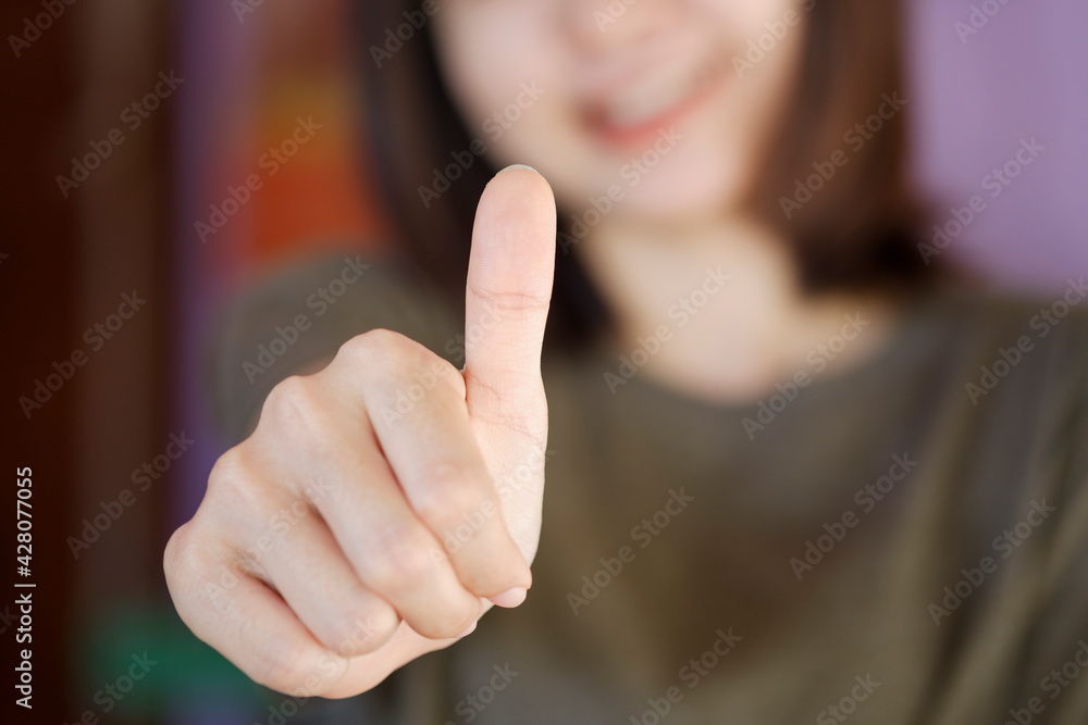 The hands of women lifted their thumbs. The concept of expressing opinions with sign language. The hands of women lifted their thumbs. The concept of expressing opinions with sign language.
