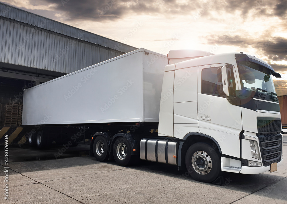 Semi Truck Parked Loading at Dock Warehouse. Cargo Shipment. Industry Freight Truck Transportation. Shipping Warehouse Logistics.
Semi Truck Parked Loading at Dock Warehouse. Cargo Shipment. Industry Freight Truck Transportation. Shipping Warehouse Logistics.