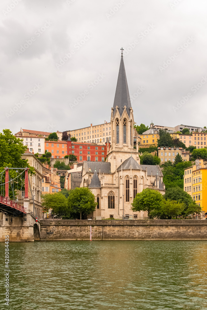 Vieux-Lyon, Saint-Georges church, colorful houses and footbridge in the center, on the river Saone 

