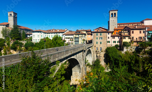 View of historic centre of Cividale del Friuli with medieval stone Devil Bridge (Ponte del Diavolo) over Natisone river, Italy