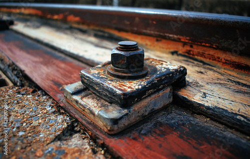 The rusty iron bolts on the railway