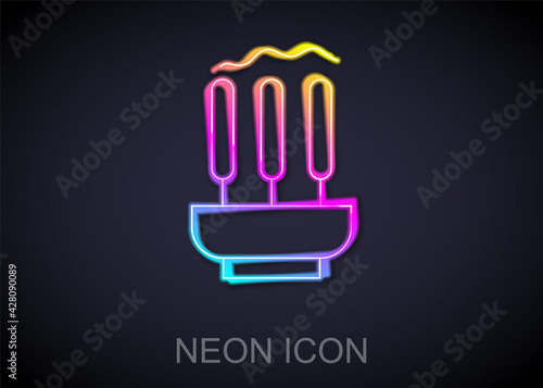 Glowing neon line Burning aromatic incense sticks icon isolated on black background. Vector