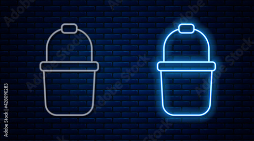 Glowing neon line Sauna bucket icon isolated on brick wall background. Vector