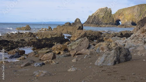 Rocks seen leaving the low tide of Kilfarrasy Beach. Co.Waterford Coastline, Ireland. Natural park protected by Unesco. stunning beach in the south of the island photo