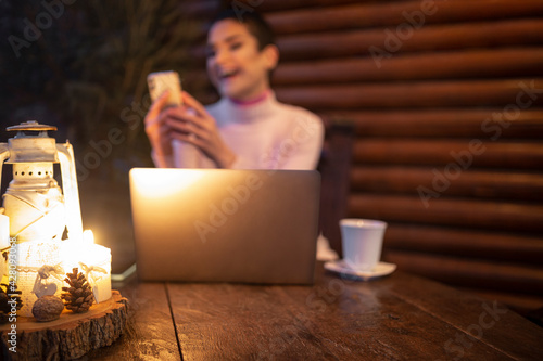 A girl sitting at a table in front of a laptop
