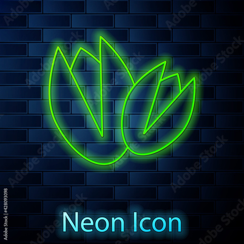 Glowing neon line Pistachio nuts icon isolated on brick wall background. Vector