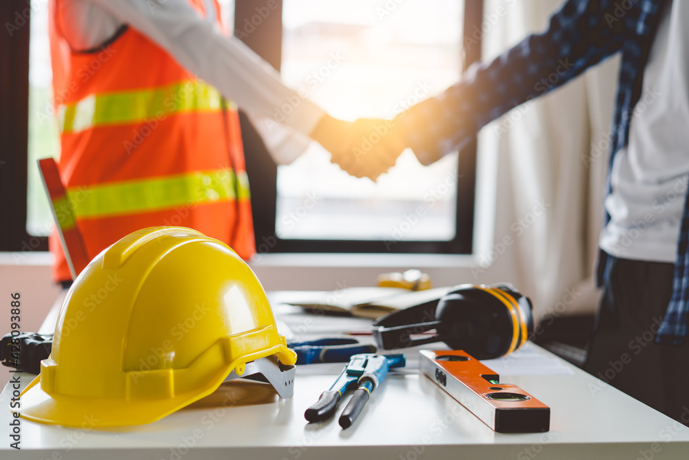 construction worker and contractor. Client shaking hands with team builder in renovation site. construction worker and contractor. Client shaking hands with team builder in renovation site.