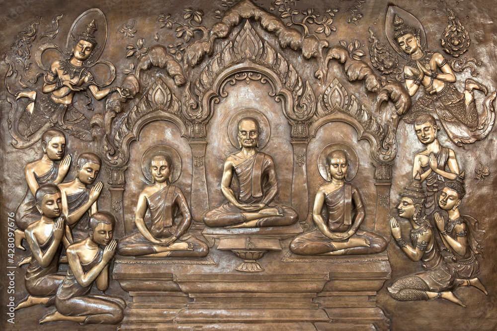 Buddha statues on temple wall in Thailand tell the story about the Buddha's history
