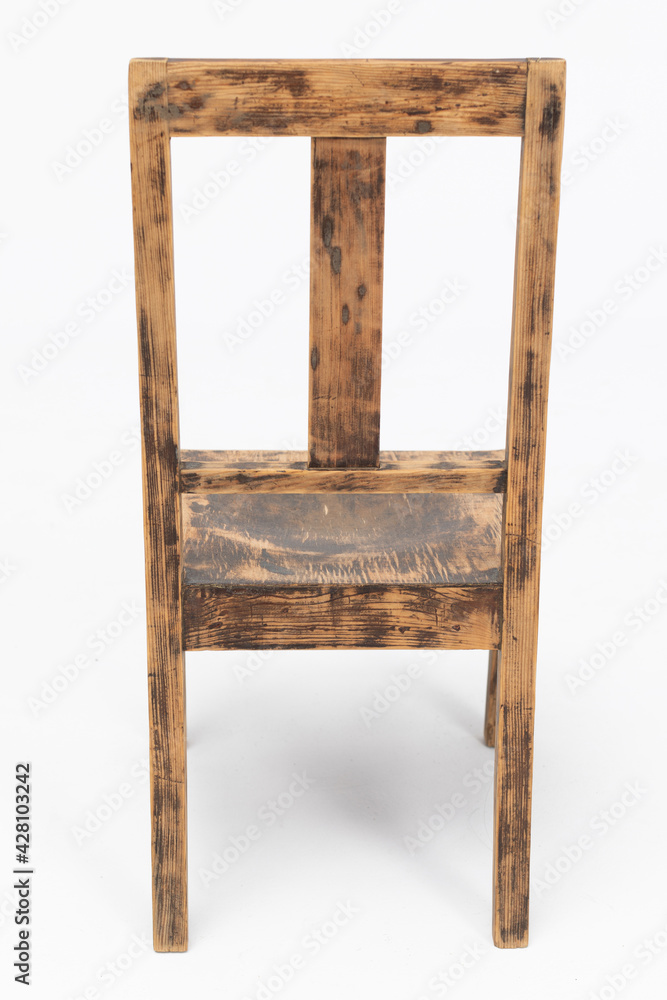 Wooden chair from the turn of the 70s and 80s from the previous century with rustic color. Short legs. Polish design and production. Rear view Wooden chair from the turn of the 70s and 80s from the previous century with rustic color. Short legs. Polish design and production. Rear view