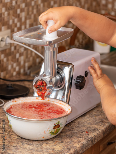 Grinding tomatoes through a meat grinder