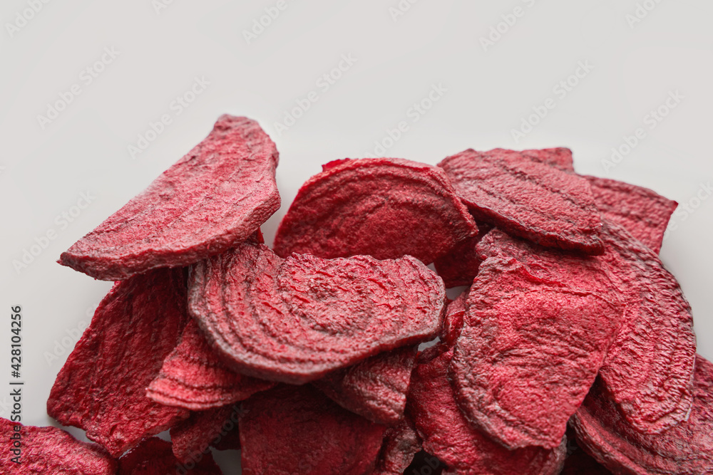 Fototapeta premium Crispy dried food. Organic tasty chips. Homemade snacks. Sliced beetfood. Healthy vegetables