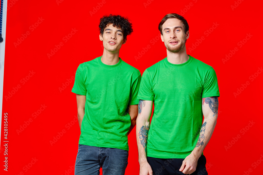 Cheerful friends stand next to communication emotions red background Cheerful friends stand next to communication emotions red background