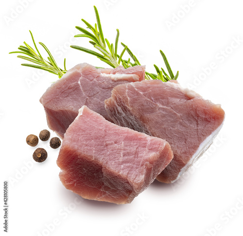 Raw, juicy and fresh chunks (dice shaped) of pork tenderloin. With rosemary leaves and black pepper. Isolated on white background.