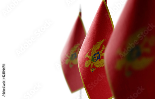 Schilderij op canvas Small national flags of the Montenegro on a white background