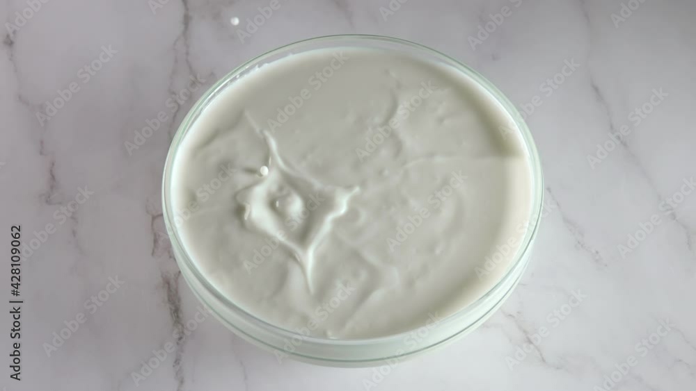 One Banana Slice Fall Into Yogurt. Slow Motion One Banana Slice Fall Into Yogurt. Slow Motion