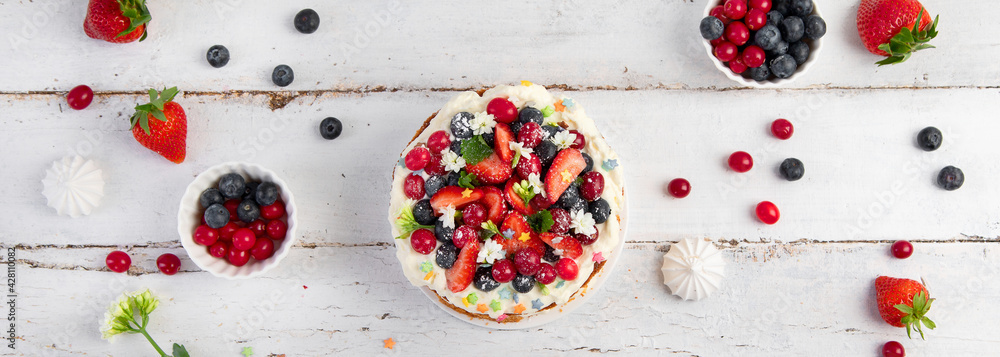 Delicious homemade cake with fresh berries and mascarpone cream on wooden background. Delicious homemade cake with fresh berries and mascarpone cream on wooden background.