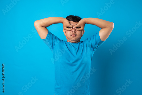 Принти на полотні young man acting silly on blue background