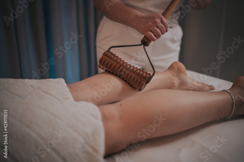 Young female getting maderotherapy massage in a spa salon photo