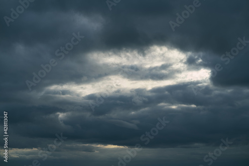 Background of dark clouds before a thunder-storm. Cumulus clouds moving in the sky. Evening sky cloudscape