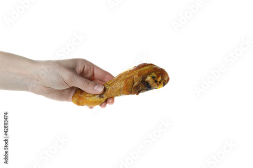 Female hand hold roast chicken drumstick, isolated on white background