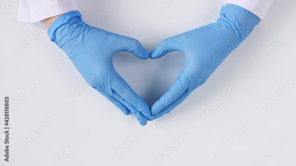 Doctor's hands in medical gloves making shape of heart on white background with copy space. High quality 4k footage Doctor's hands in medical gloves making shape of heart on white background with copy space. High quality 4k footage