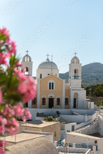 Santorini traditional village church with a white dome and two bell towers