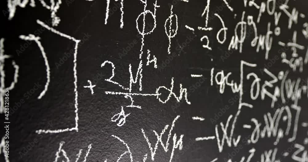 Dark black chalk board with mathematical formulas on it Dark black chalk board with mathematical formulas on it