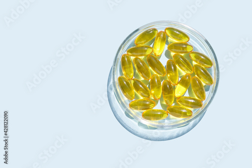 Omega3 gel capsule. Sun shadow. Yellow vitamin. Health eating. Dietology drug. Fish oil supplement. Nutritional concept. Golden softgel collagen. Medicine immunity cosmetics