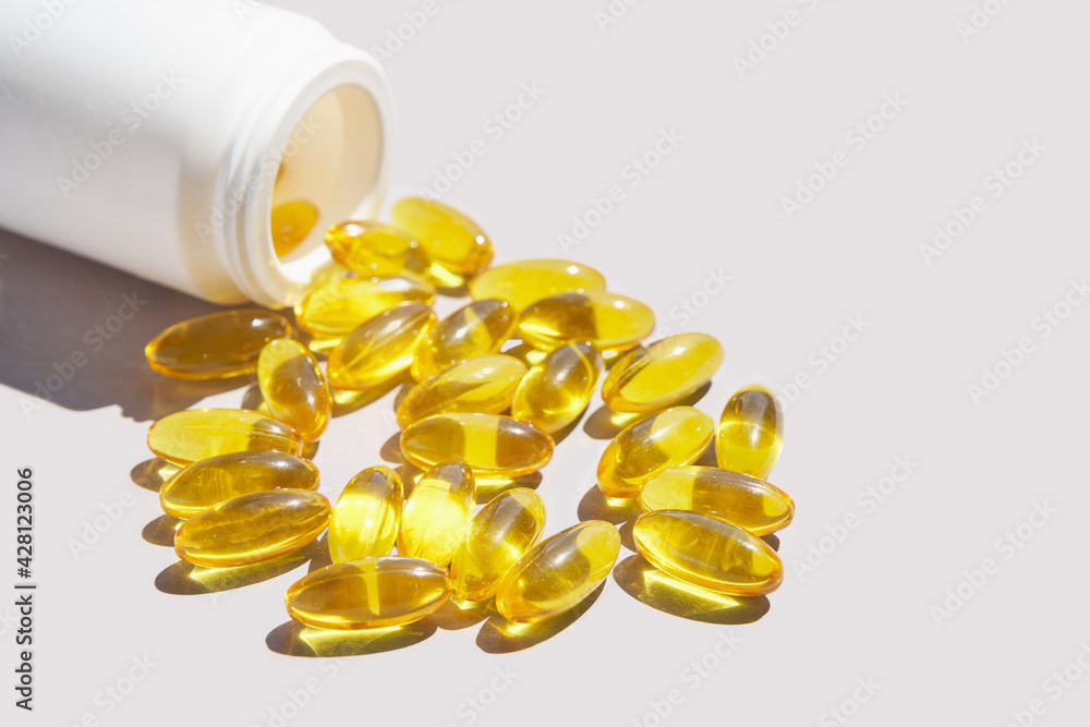Omega3 gel capsule. Sun shadow. Yellow vitamin. Health eating. Dietology drug. Fish oil supplement. Nutritional concept. Golden softgel collagen. Medicine immunity cosmetics Omega3 gel capsule. Sun shadow. Yellow vitamin. Health eating. Dietology drug. Fish oil supplement. Nutritional concept. Golden softgel collagen. Medicine immunity cosmetics