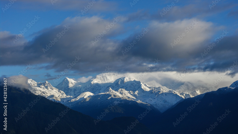 Beautiful sunrise panorama on snow-capped Kangchenjunga mountain in Himalaya range seen from Pelling, Sikkim, India