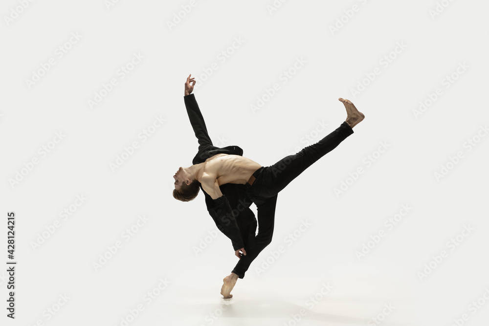 Man in casual style clothes jumping and dancing isolated on white background. Art, motion, action, flexibility, inspiration concept. Flexible caucasian ballet dancer.