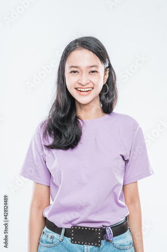 beautiful young girl smiling at the camera with jeans pants isolated on a white background