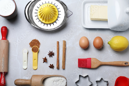 Cooking utensils and ingredients on light marble table, flat lay