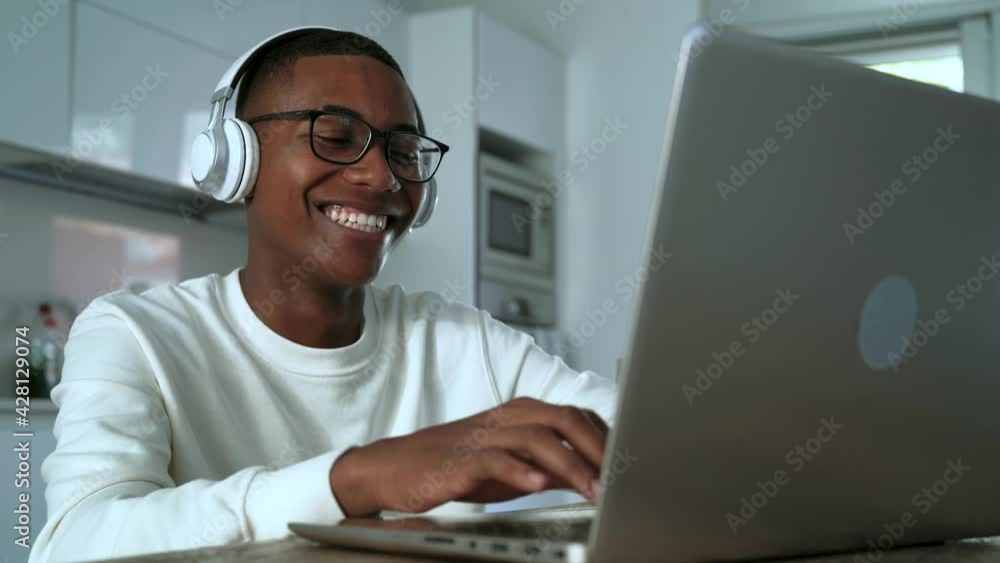 Happy Latin man having fun doing video call using laptop at home - Technology and communication concept
