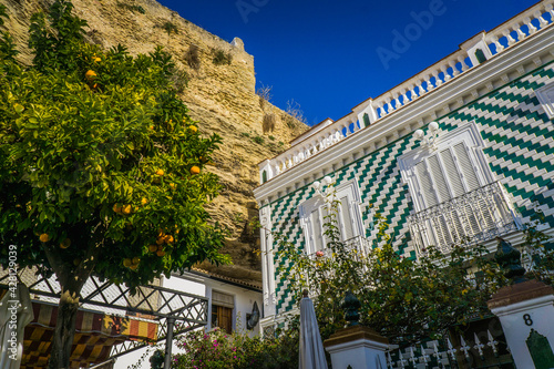 Wallpaper Mural Beautiful tile facade and orange tree in Setenil de las Bodegas, one of the most famous white village (pueblo blanco) of Andalusia (Spain) Torontodigital.ca