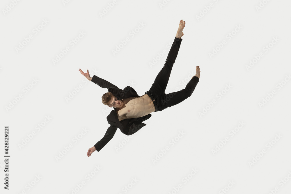 Man in casual style clothes jumping and dancing isolated on white background. Art, motion, action, flexibility, inspiration concept. Flexible caucasian ballet dancer. Man in casual style clothes jumping and dancing isolated on white background. Art, motion, action, flexibility, inspiration concept. Flexible caucasian ballet dancer.