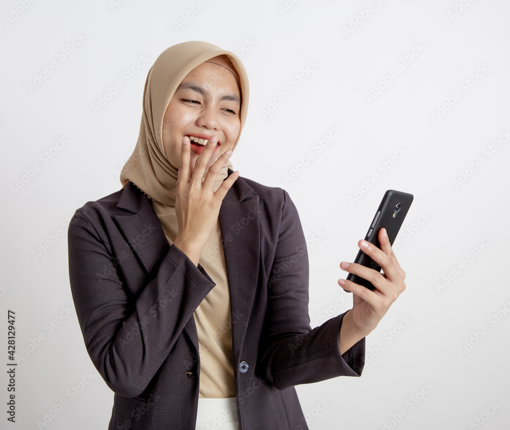 women wearing suits hijab laugh looking at the phone, formal work concept isolated white background women wearing suits hijab laugh looking at the phone, formal work concept isolated white background