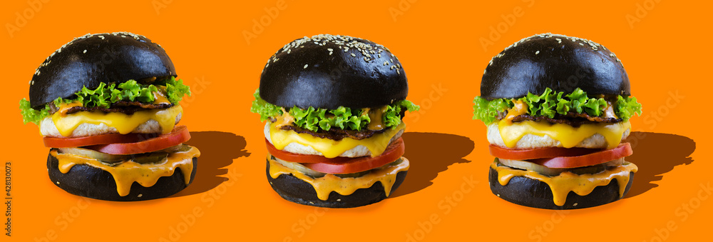 chicken burgers in a black bun on an orange background