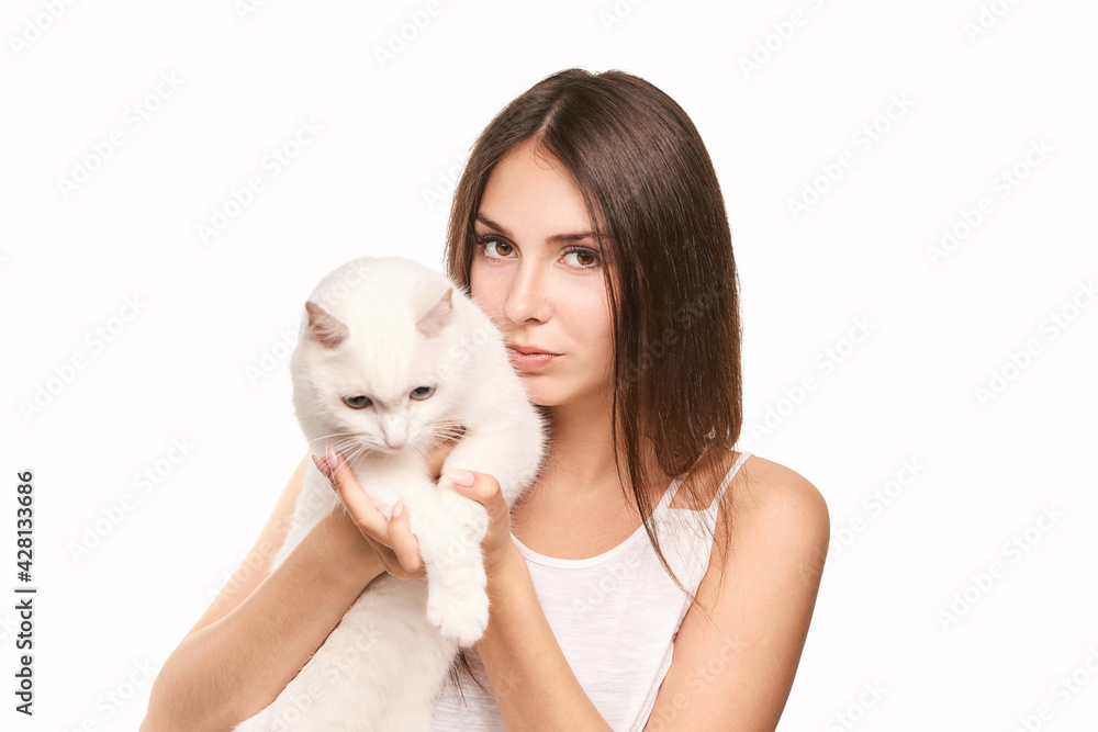 Young woman holding white cat. Allergy concept. Pretty animal. Lifestyle. Human and pet Young woman holding white cat. Allergy concept. Pretty animal. Lifestyle. Human and pet