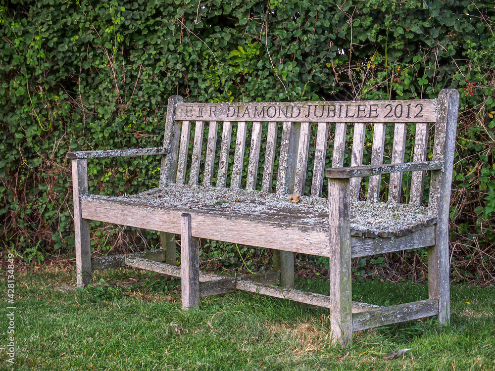 Wooden bench in rural village setting commemorating Queen Elizabeth the Second Diamond Jubilee 2012 Wooden bench in rural village setting commemorating Queen Elizabeth the Second Diamond Jubilee 2012