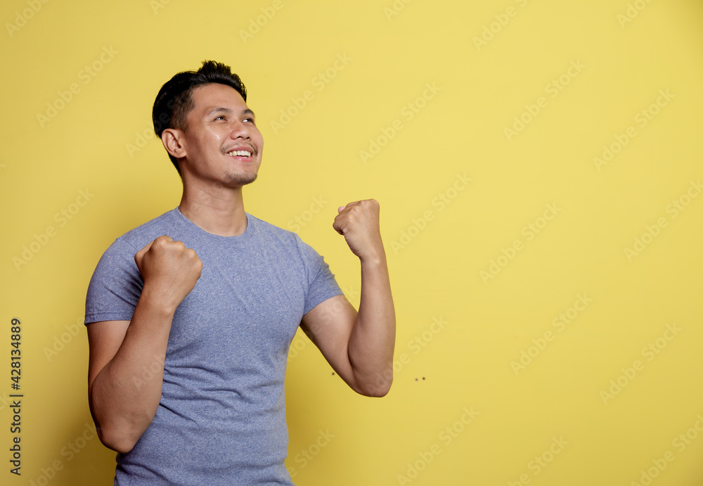 handsome man smile expression very spirit isolated on a yellow color background handsome man smile expression very spirit isolated on a yellow color background