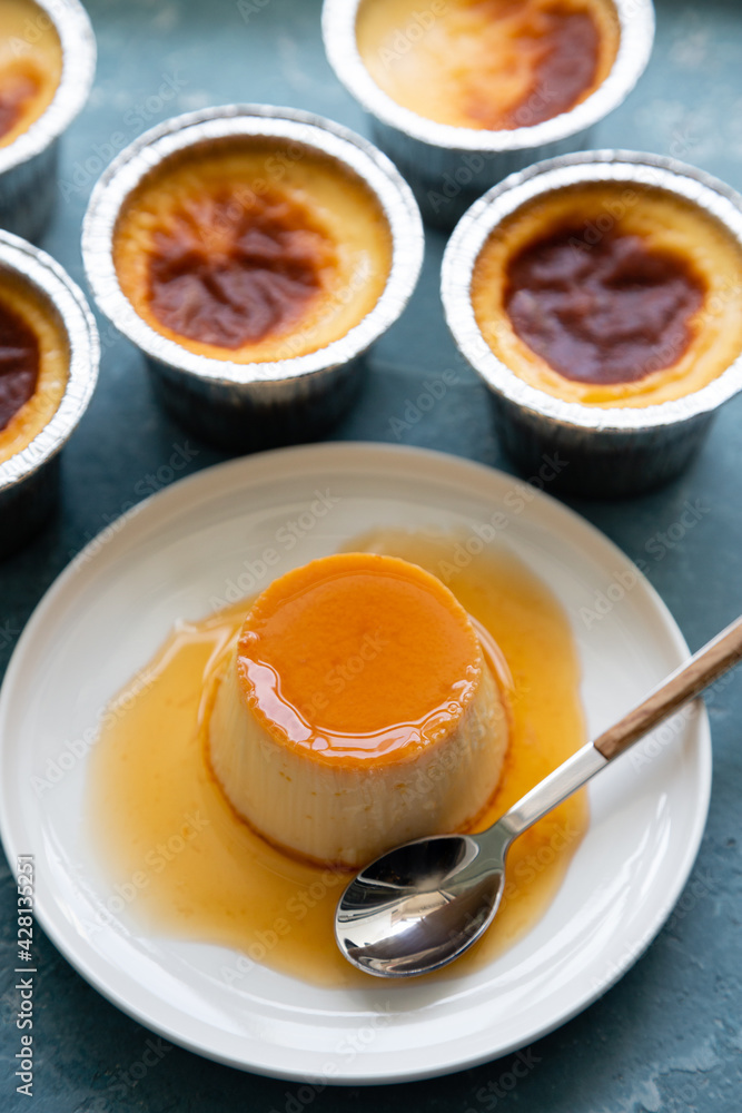 Flan or creme caramel on a blue rough background Flan or creme caramel on a blue rough background