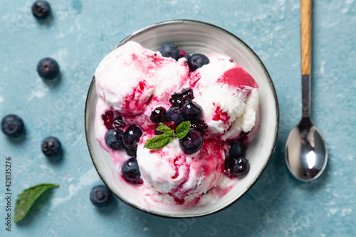 Top view of yogurt and blueberry ice cream with natural blueberry syrup