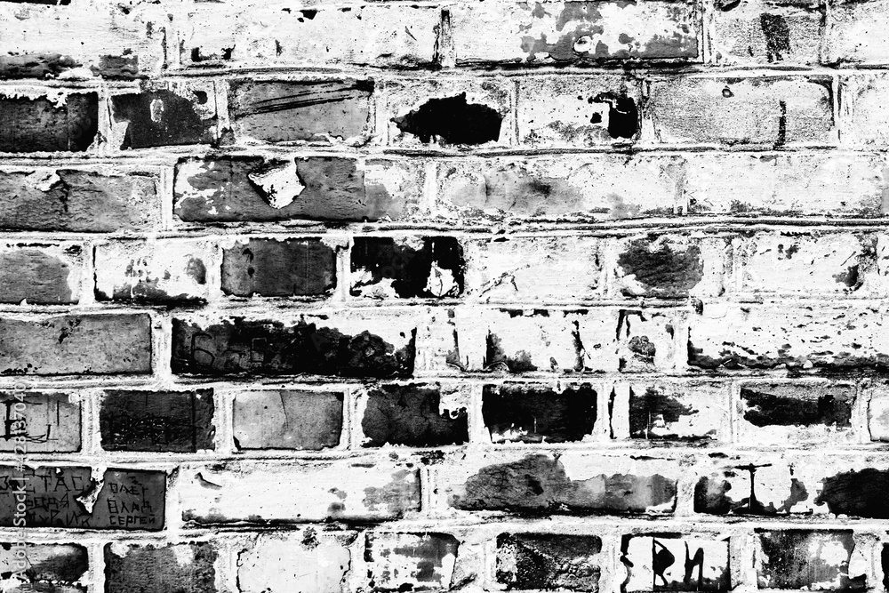 Fototapeta premium Texture of a brick wall with cracks and scratches which can be used as a background