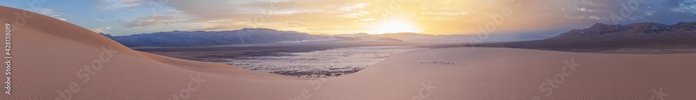 Eureka Dune at sunset is illuminated by a gentle pink light against a backdrop of dramatic clouds, Death Valley National Park, USA Eureka Dune at sunset is illuminated by a gentle pink light against a backdrop of dramatic clouds, Death Valley National Park, USA