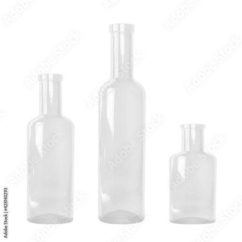 Three empty transparent bottles in different sizes, all without label, isolated on white background