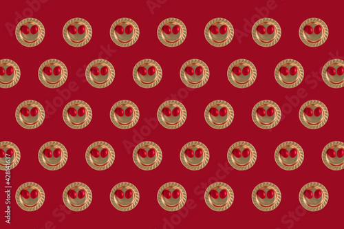 Easter festive pattern 2021 made of Easter happy emotion emojis with Easter eggs in gold plates on bold red background. Minimal 2021 flat lay concept.