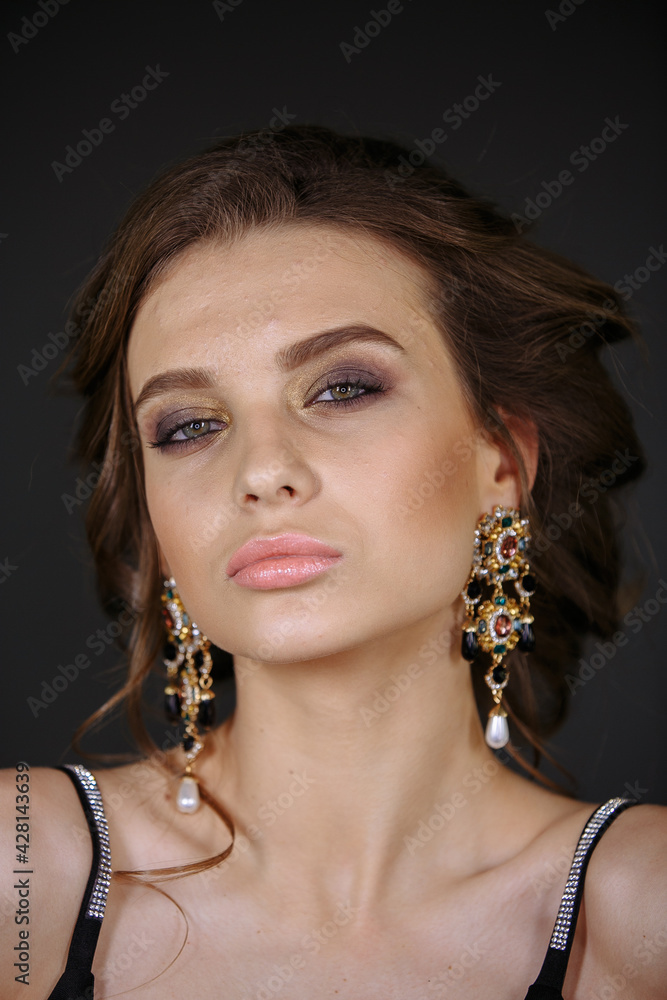 portrait of a model on a dark background with a bright make-up
