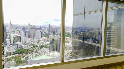 Office building window interior deign with modern city skyline background  Beautiful real estate building and skyscrapers in Bangkok Thailand