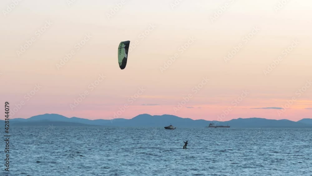 01 September, 2018. Vladivostok city, Russia. Kite-surfing against a beautiful sunset. Silhouette of kitesurfer. Holidays on nature. Artistic picture. 01 September, 2018. Vladivostok city, Russia. Kite-surfing against a beautiful sunset. Silhouette of kitesurfer. Holidays on nature. Artistic picture.